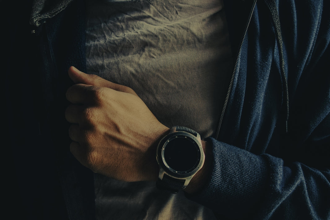 person wearing silver and black round watch