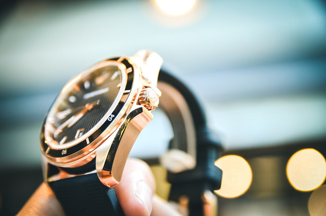 a person holding a watch in their hand