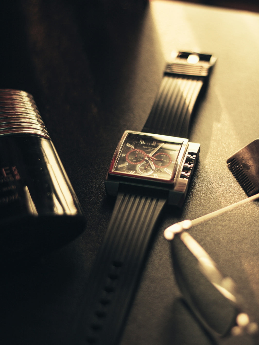 a couple of watches sitting on top of a table