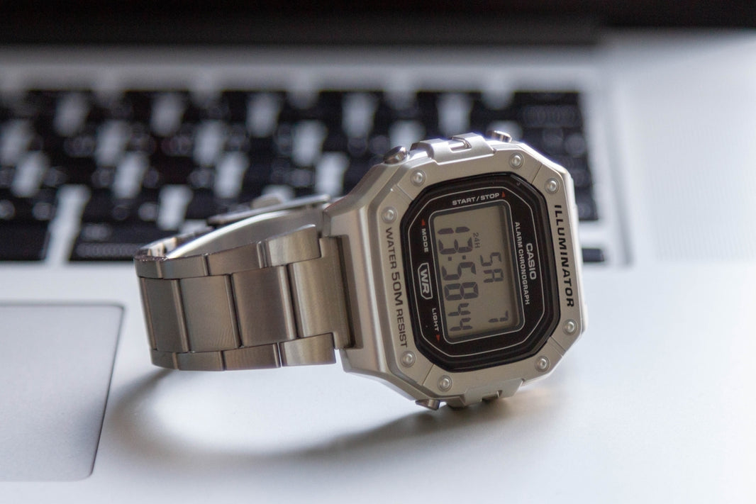 A watch sitting on top of a computer keyboard